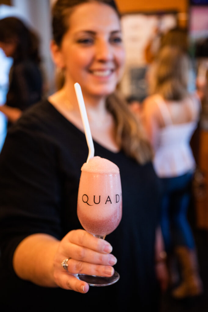 KC Cornwell holding a wine slushie at Quady Winery in Madera County