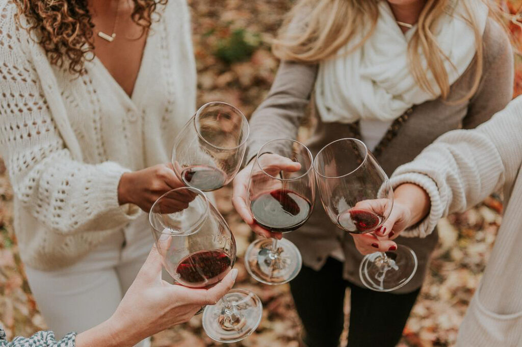 women toasting with red wine in gold country