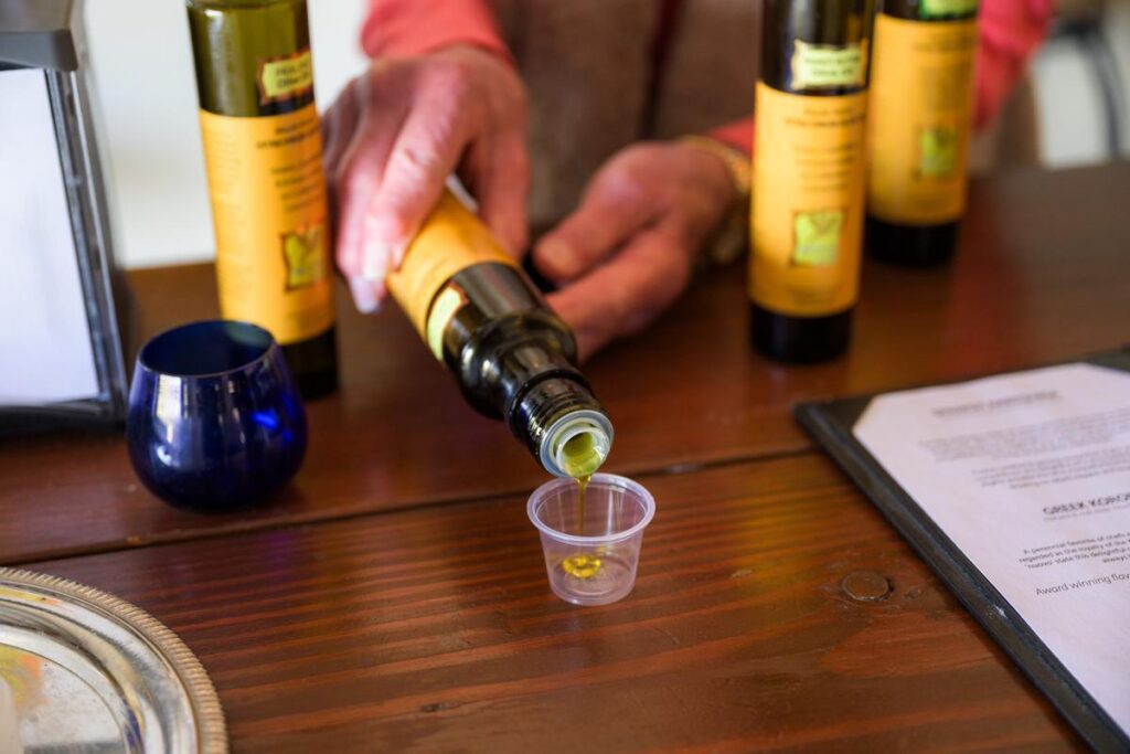 woman pouring sample of olive oil