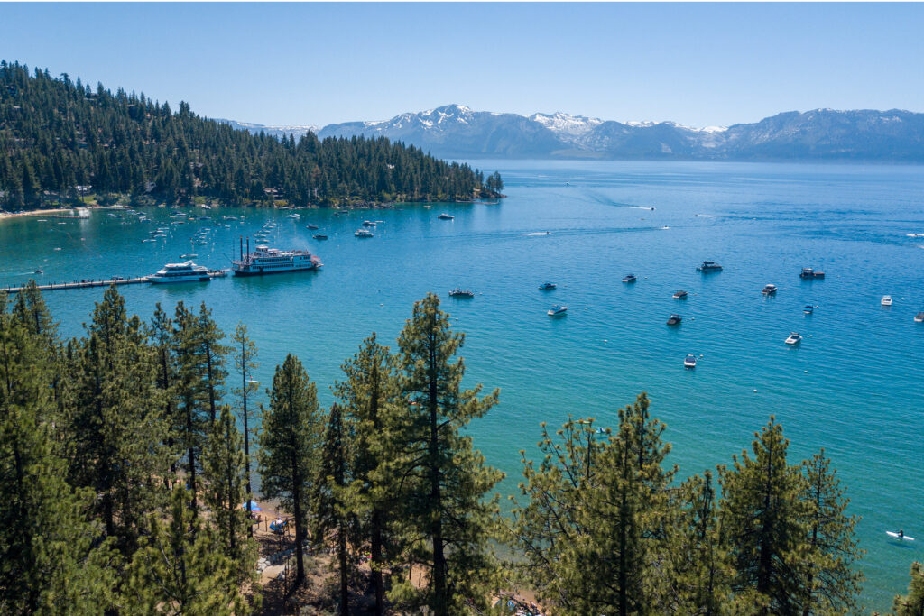 Aerial view of lake with snow-capped mountains in background