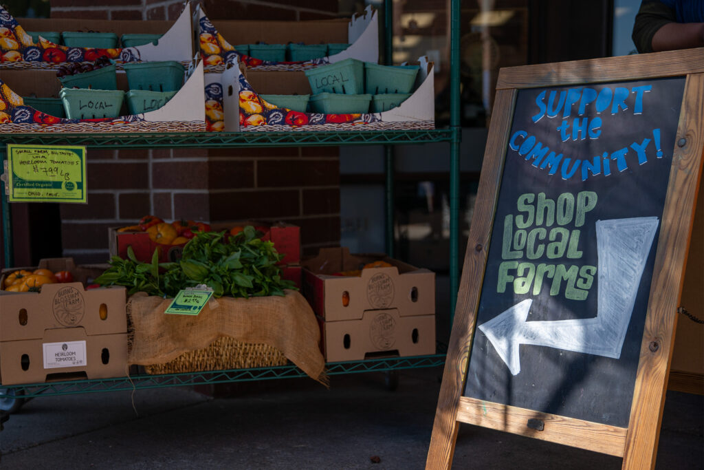 Chalkboard sign next to local produce