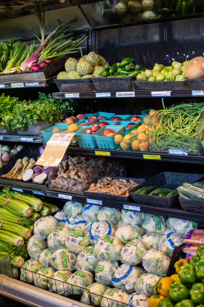 Cooler of local produce like green beans, artichokes, chiles, tomatillos, celery, and cauliflower
