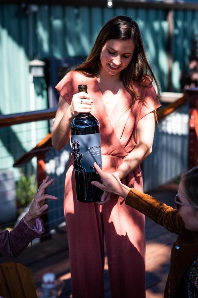 woman holding magnum size bottle of red wine at desparada