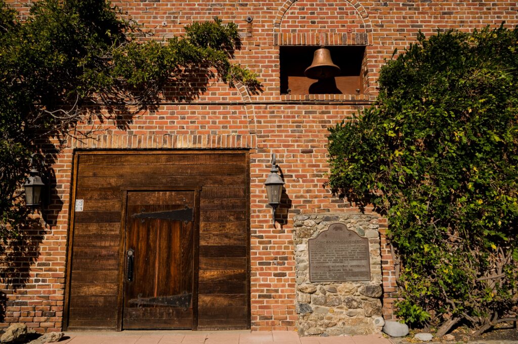 Exterior of a brick building with a landmark marker in Livermore wine country