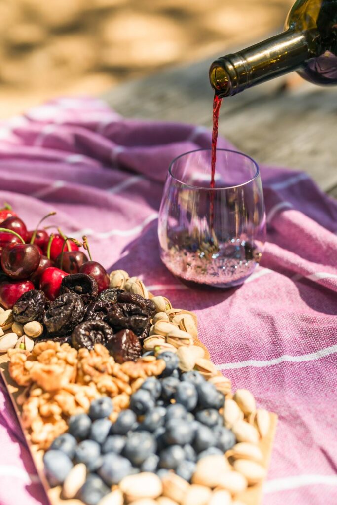 pouring wine outdoors for a Northern California glamping trip 