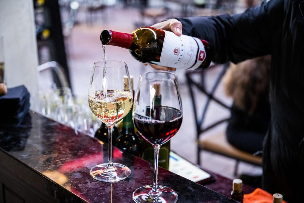 woman pouring wine at europa village