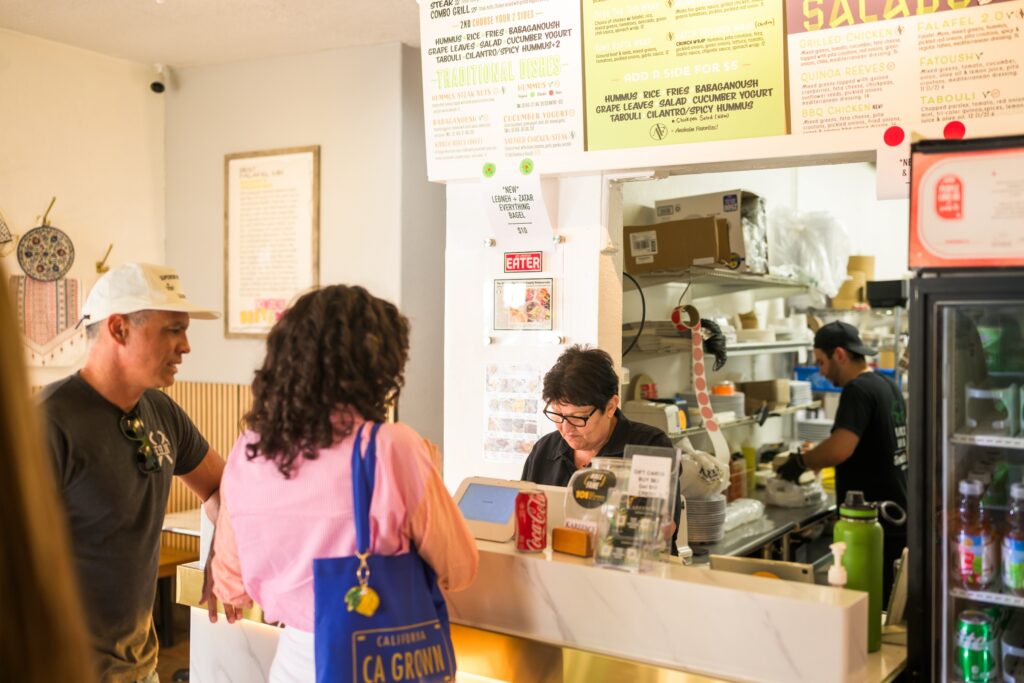 Two people ordering food at a cafe