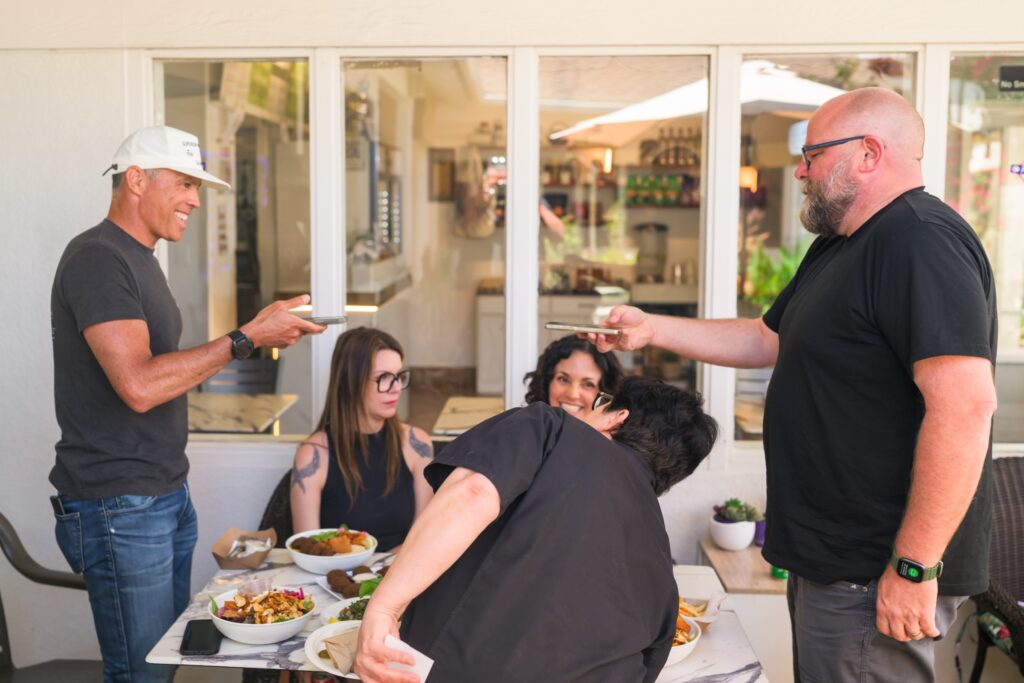 People standing around a table taking photos