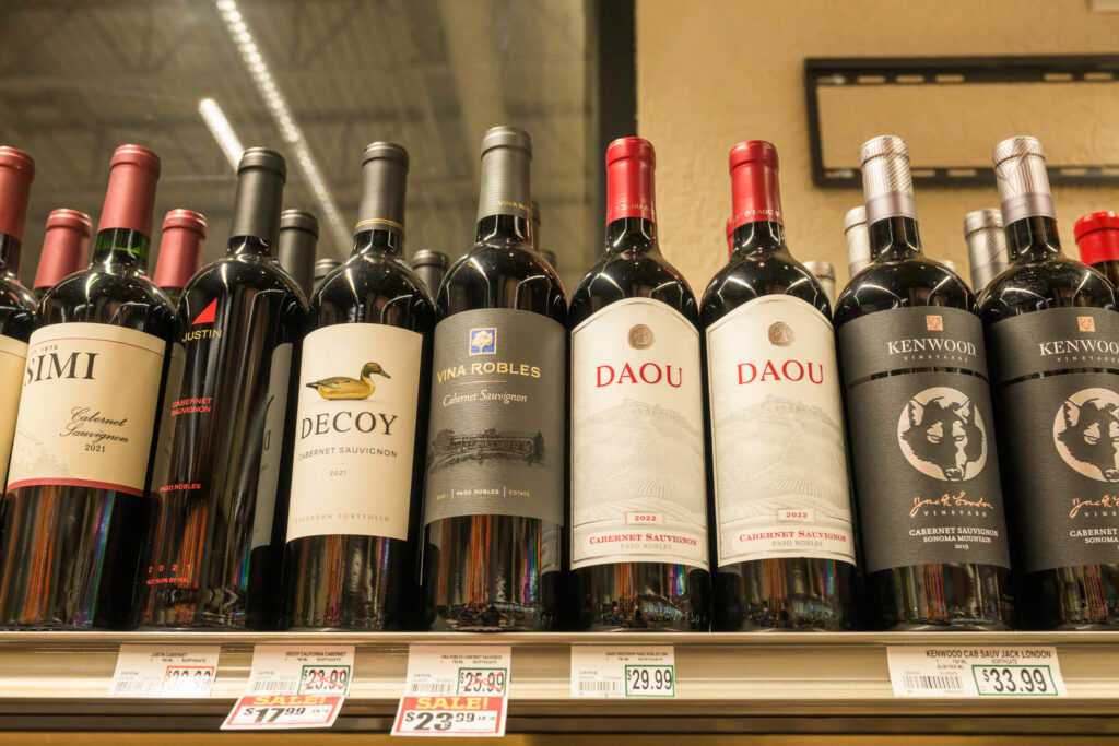 Bottles of various California wines on a shelf at astore