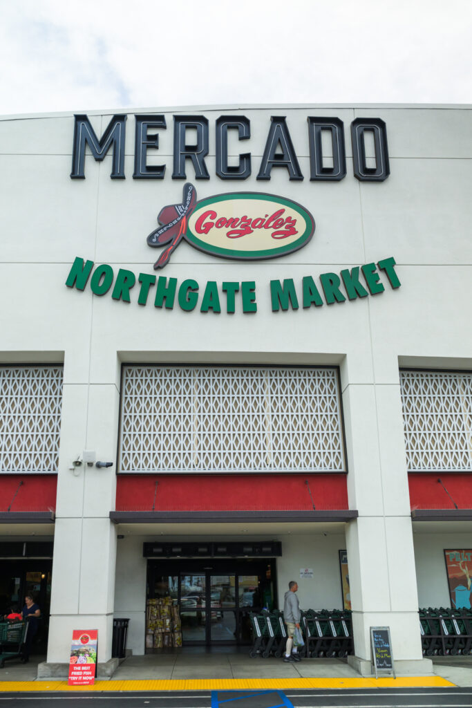 Exterior shot of a grocery store with a sign
