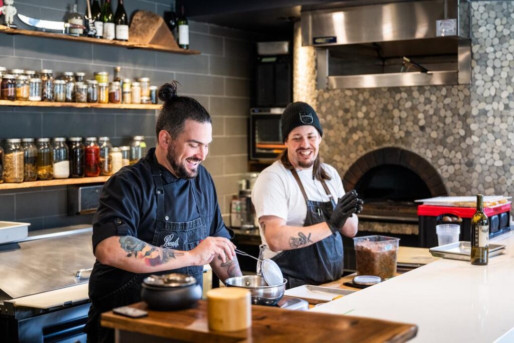 Chef Christopher Dann and a member of his culinary team at Localis, a farm-to-fork restaurant