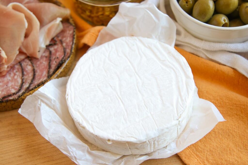 wheel of marin cheese brie on a wooden board