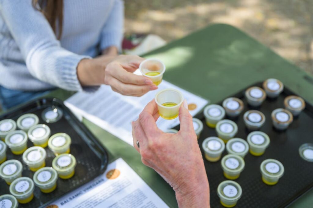 two woman toasting with mini olive oil cups